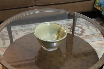Green footed bowl. Footed bowl in a green glaze breaking to iron at the rim.