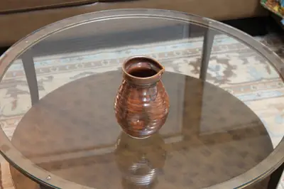 Small brown pitcher. Small pitcher in a red-brown glaze.