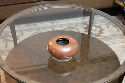 Closed form. Round, low closed form in a glossy red-brown glaze.