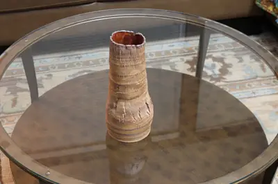 Textured series: tall vase. Tall vase with a cracked, textured surface and torn rim.