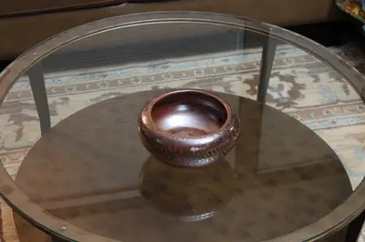 Carved low bowl. Low dark bowl with a carved band.