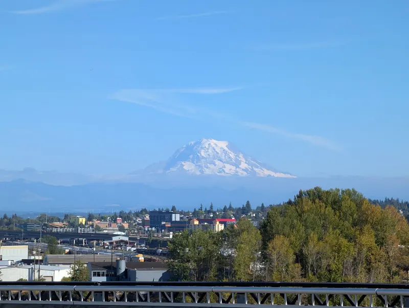Snow-covered Mount Rainier rising above the Tacoma tideflats and city on a clear day