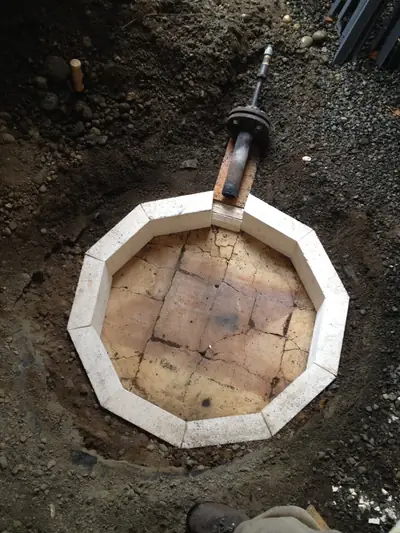 Foundation. The firebrick floor and burner port set into the ground.