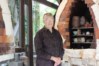 Elinor Maroney standing in front of the soda kiln