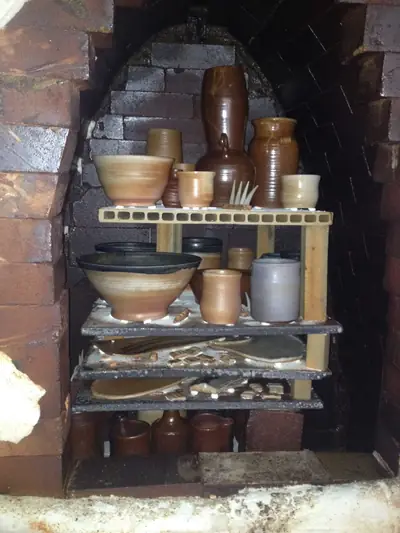 Unloading. Fresh soda-fired pots on the shelves.